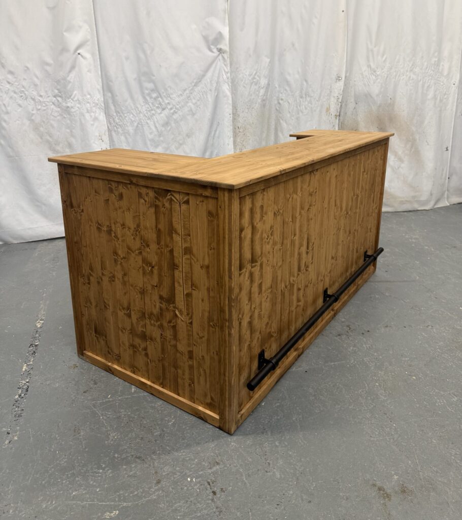 large corner bar with black foot rail and fridge compartment in satin shade