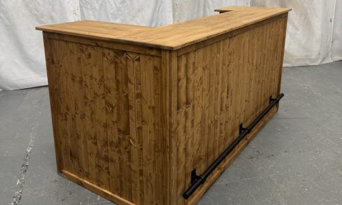 large corner bar with black foot rail and fridge compartment in satin shade